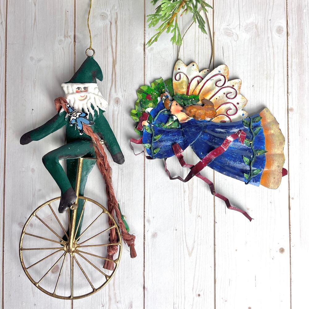 VTG Lot of 2 Painted Metal Ornaments Folk Art Santa on Unicycle & Flying Angel